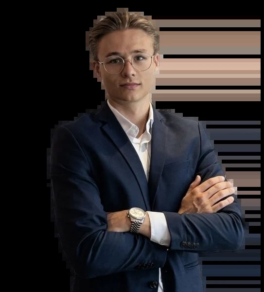 Professional man in dark blue suit and glasses with arms crossed against black background